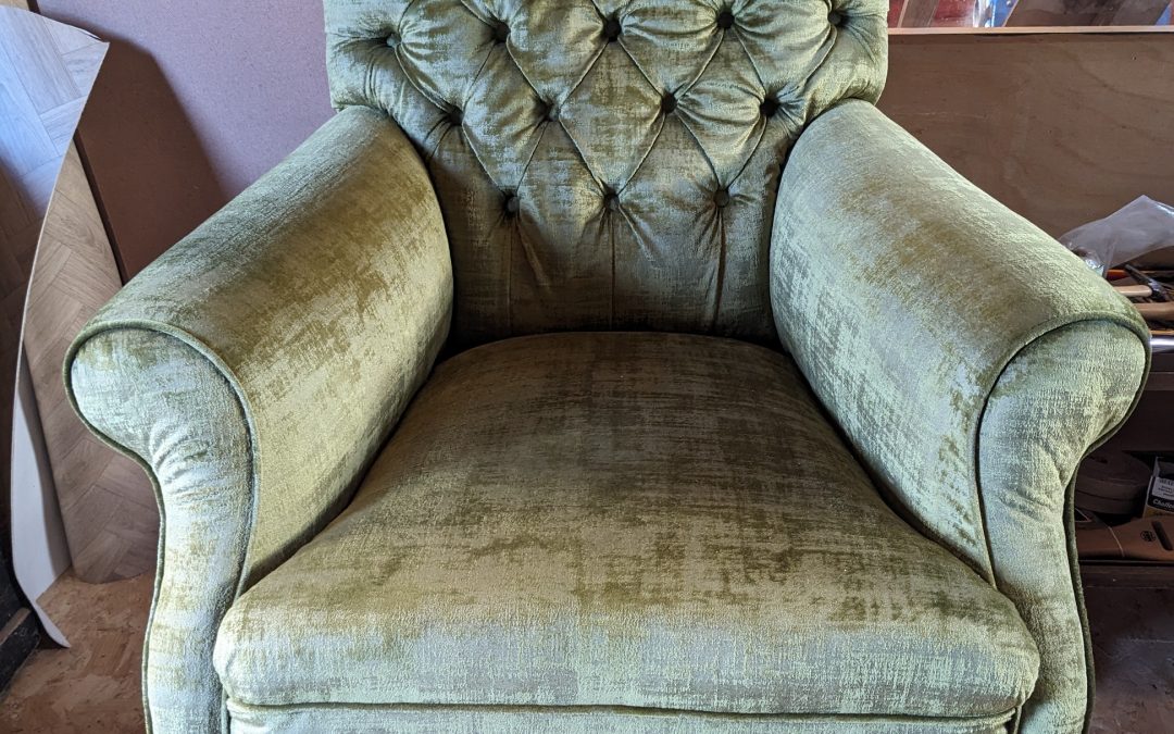 Green velvet button back armchair