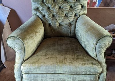 Green velvet button back armchair